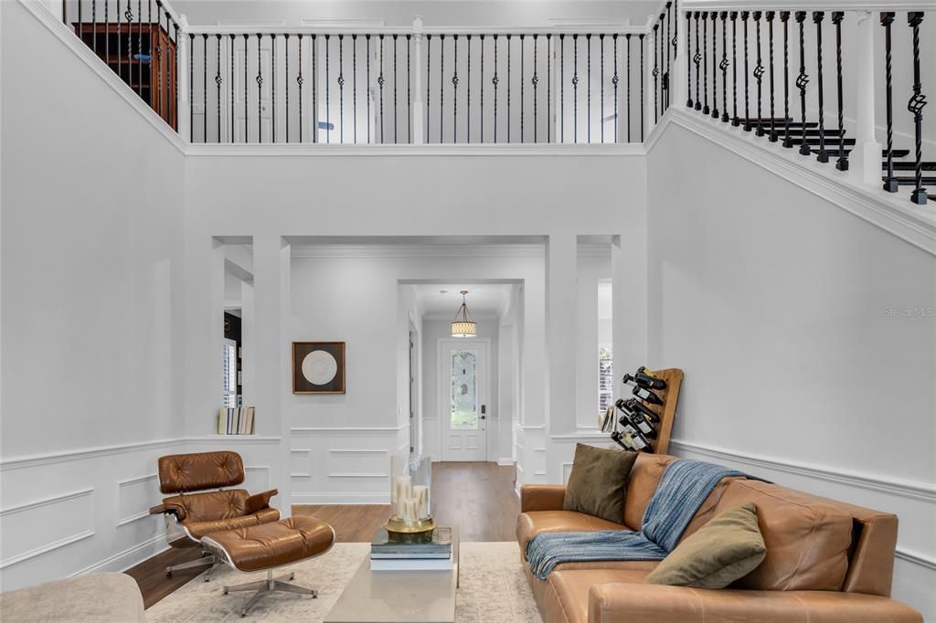 Formal Living Room  Enjoys 2 story vaulted ceiling with huge windows