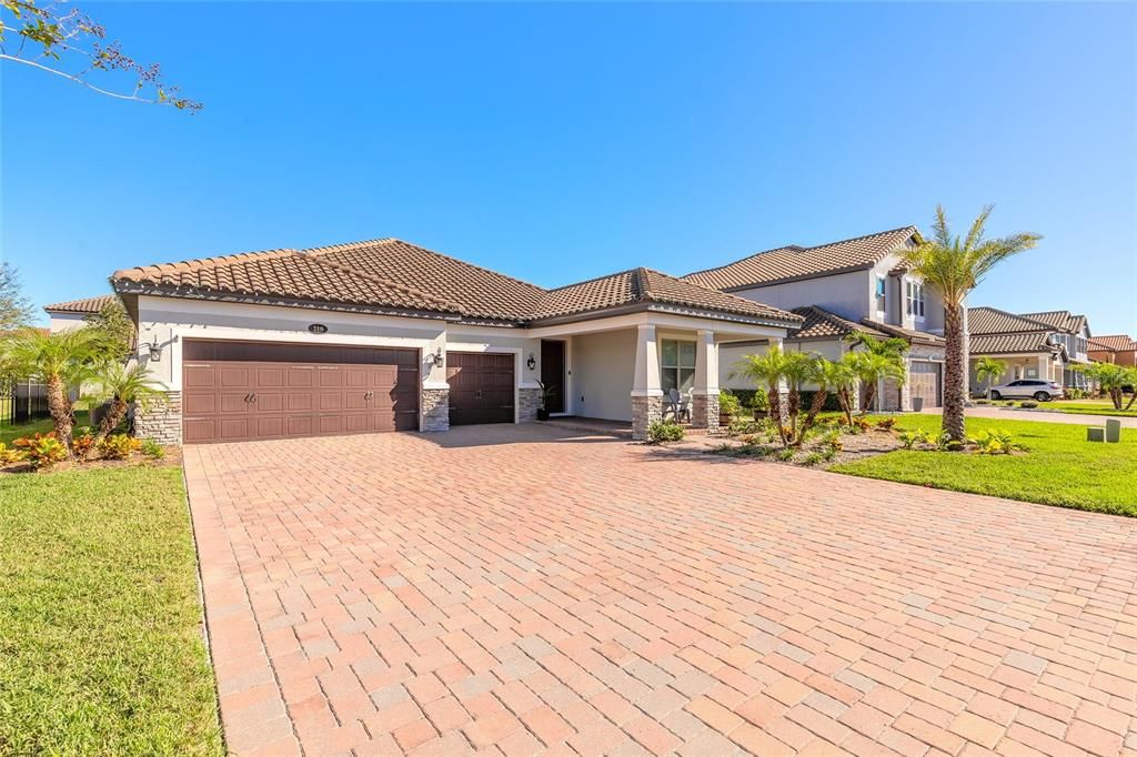 3 car garage with paver driveway