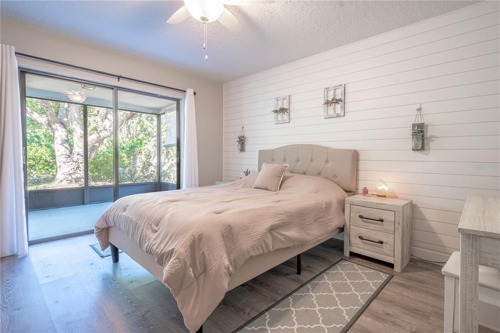 Sliding doors lead to the lanai, inviting abundant natural light and offering seamless indoor-outdoor living. This primary bedroom blends modern amenities with cozy details for the ultimate personal retreat and an ensuite bath for added convenience.