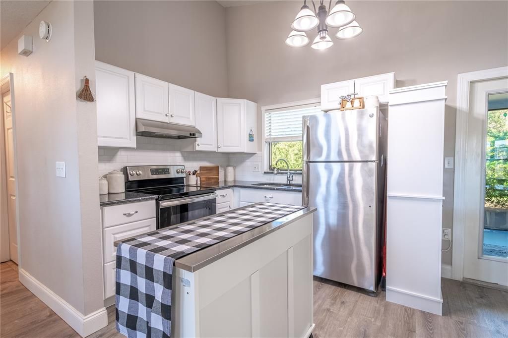 The kitchen features a movable island with storage.