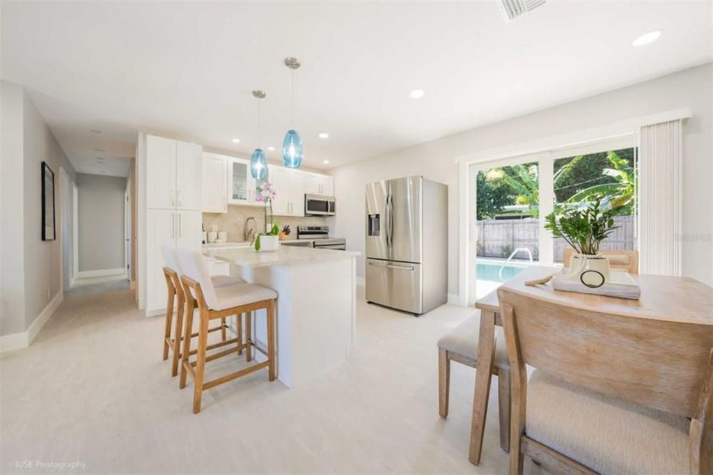 Kitchen, Breakfast Bar, Eating Area and Doors to the Patio