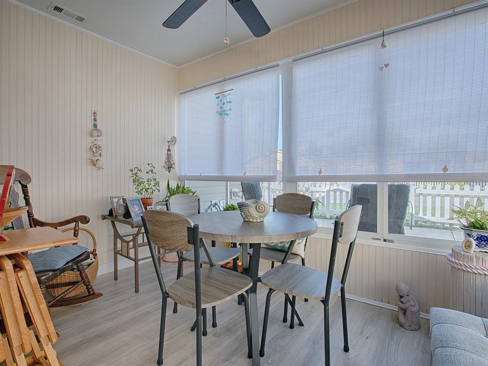 ENCLOSED PORCH LANAI HAS GORGEOUS LAMINATE FLOORING AND PRIVACY SHADES