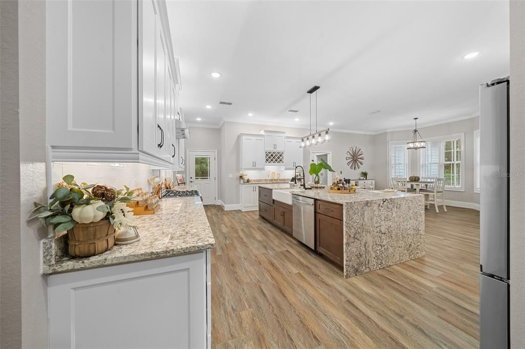 New Kitchen With Large Island With Granite Waterfall