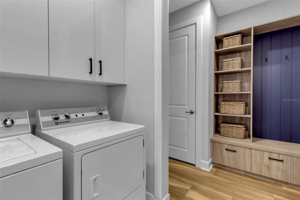 Laundry room has been custom fitted- don't be shy- open the cabinets to see all the design features. Yes, the washer and dryer convey with the home