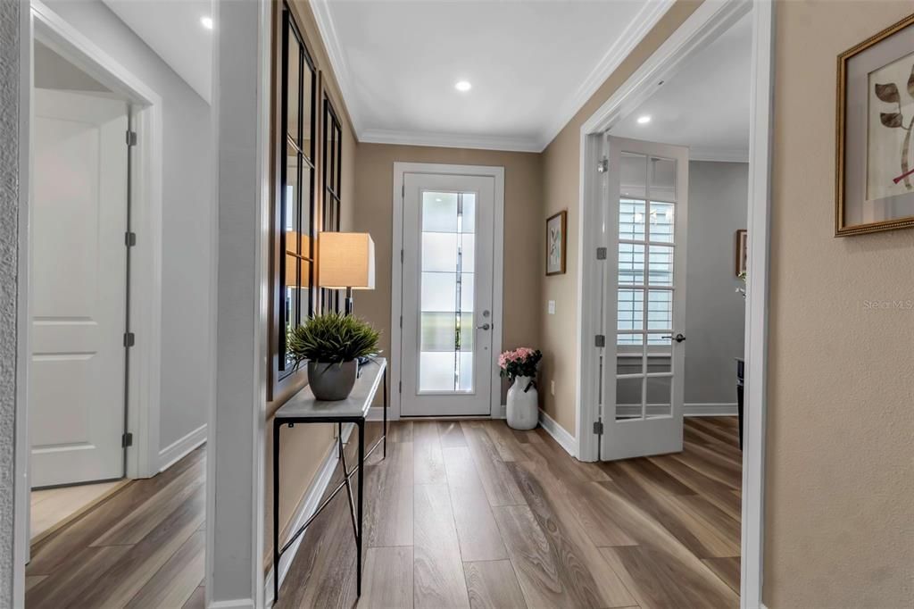 Warm wood tone of Luxury Vinyl plank flooring welcomes you into this home. Full glass view front door provides ample light