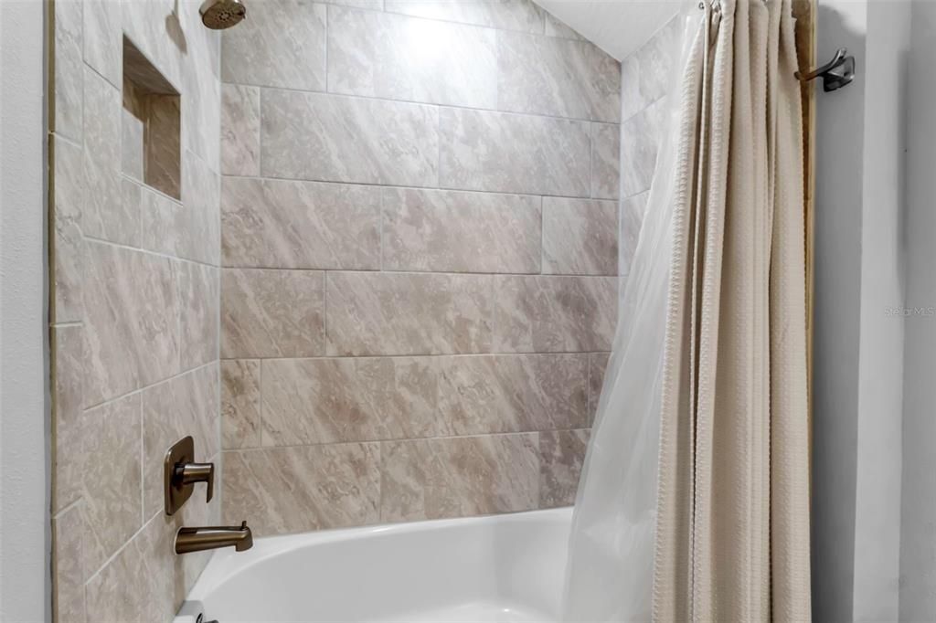 Tile surround the shower/ tub combination