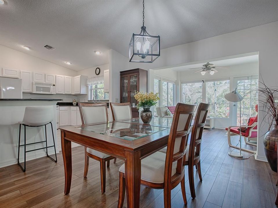 DINING ROOM AREA WITH A VIEW INTO THE BEAUTIFUL FLORIDA ROOM