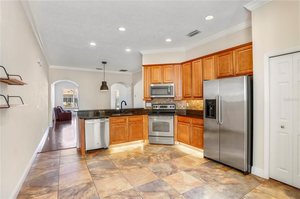 Stainless steel appliances, granite counter tops, and beautiful tile floors