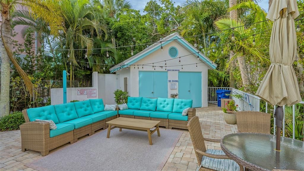 Gathering area and pool house by community pool.