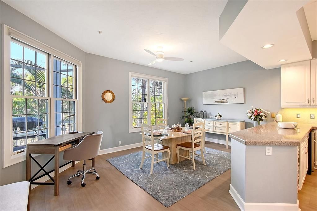 Eat in kitchen with peninsula island overlooking backyard pond with water. feature