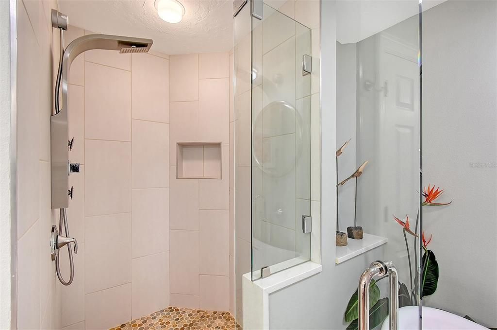 Walk in shower with rain head and multi water feature options.