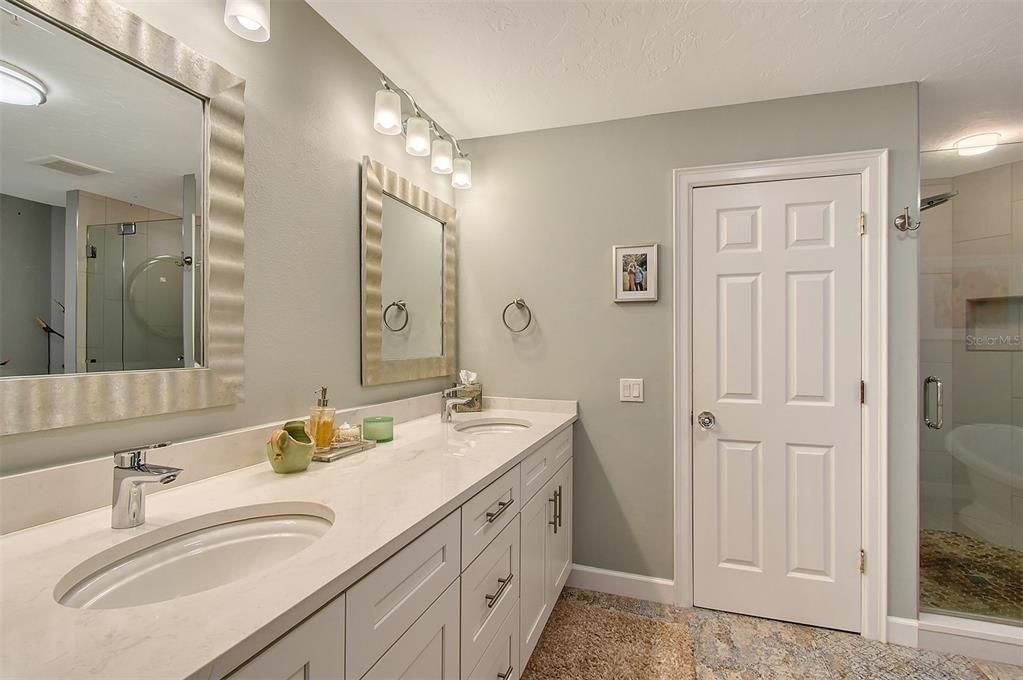 Primary bathroom suite with dual sinks and private water closet.