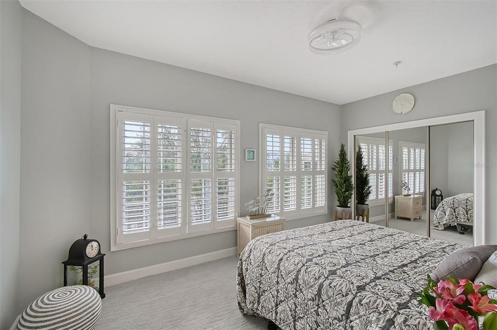 Bedroom 2 with en-suite bathroom overlooking front pond with water feature.