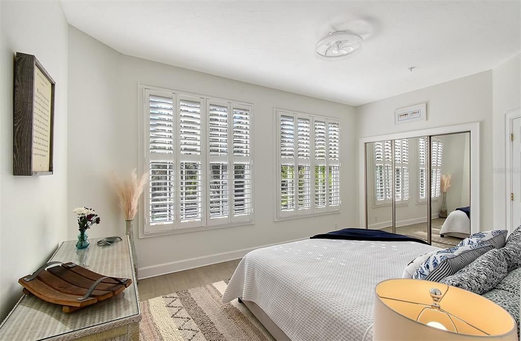 Bedroom 1 with en-suite overlooking front pond with water feature.