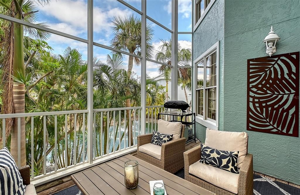 Treetop lanai overlooking pond with fountain.