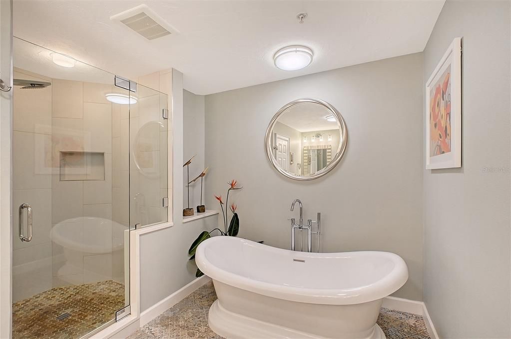 Primary suite with soaking tub and large walk in shower.