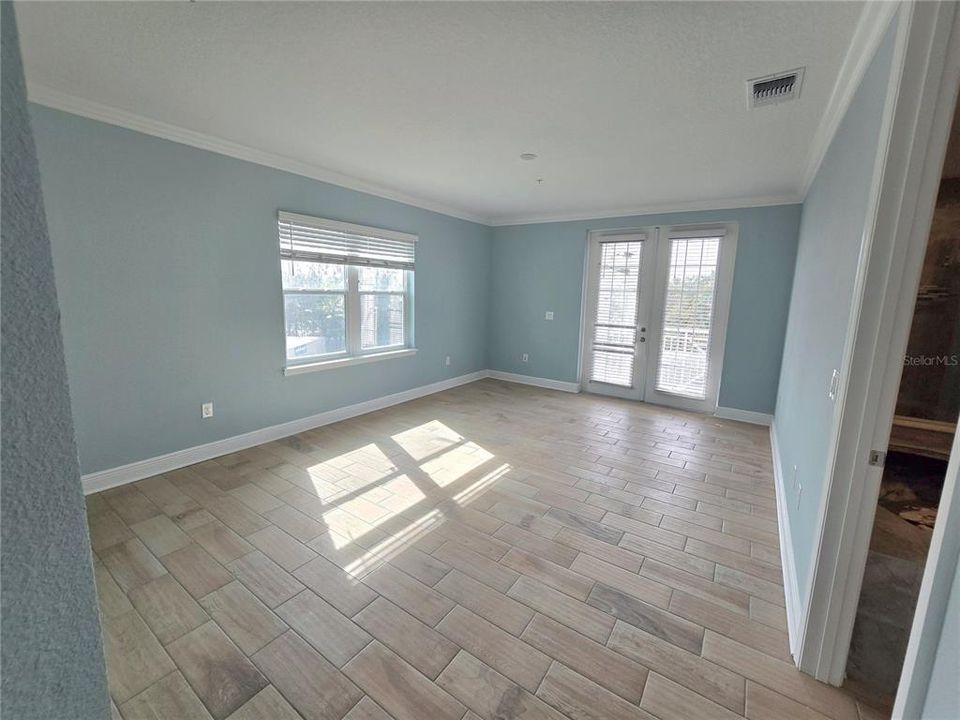 Large light filled primary BR with covered balcony/porch