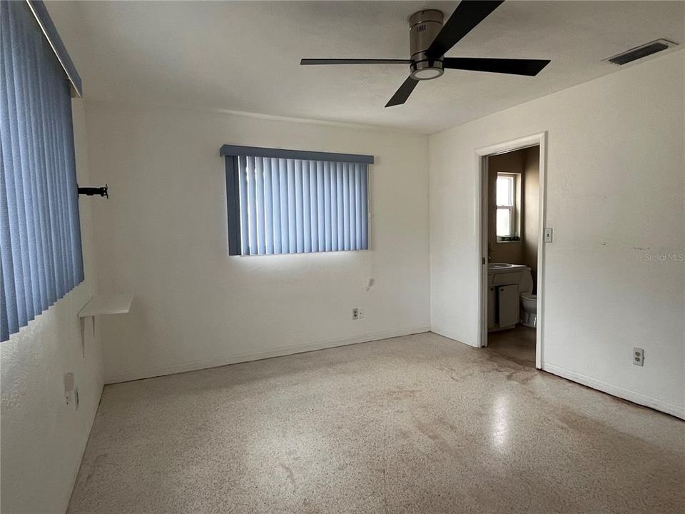 Primary bedroom with terrazzo floors