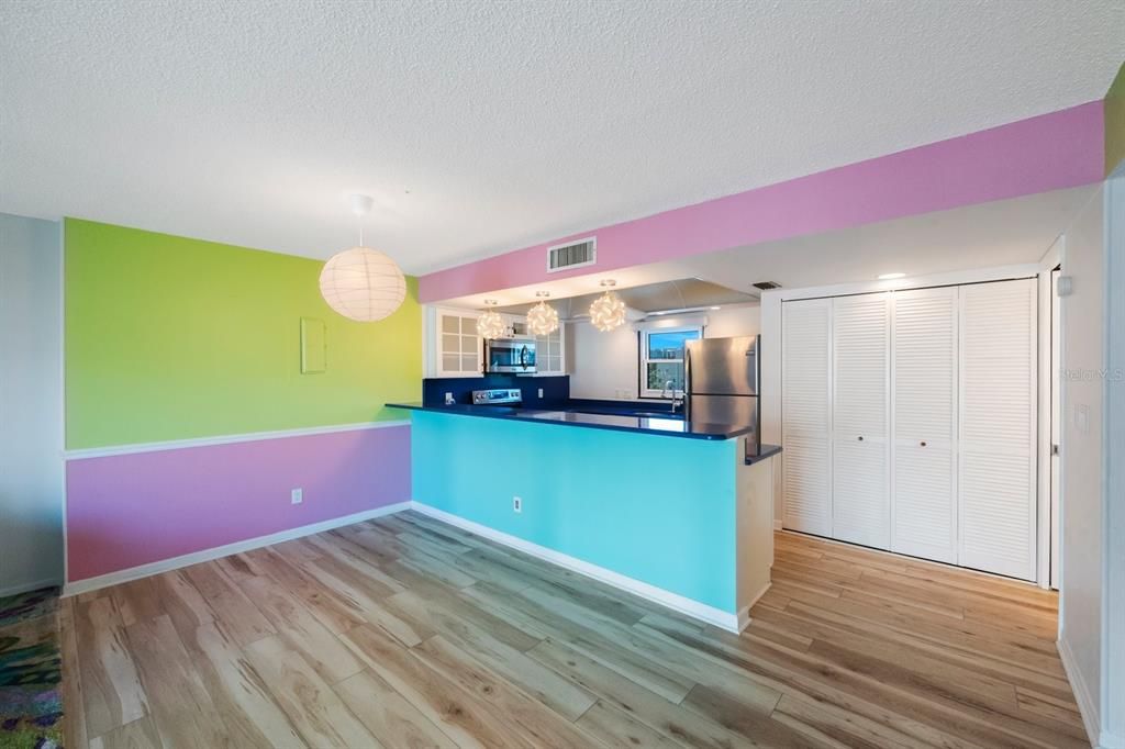 Charming whimsical light fixtures provide plenty of brilliance.  Folding doors to right provide access for stackable washer and dryer.