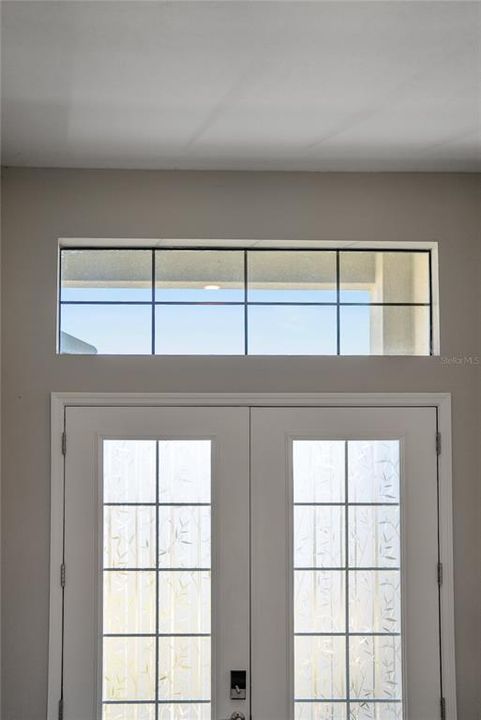 French Door Entryway opens into 12' high ceilings