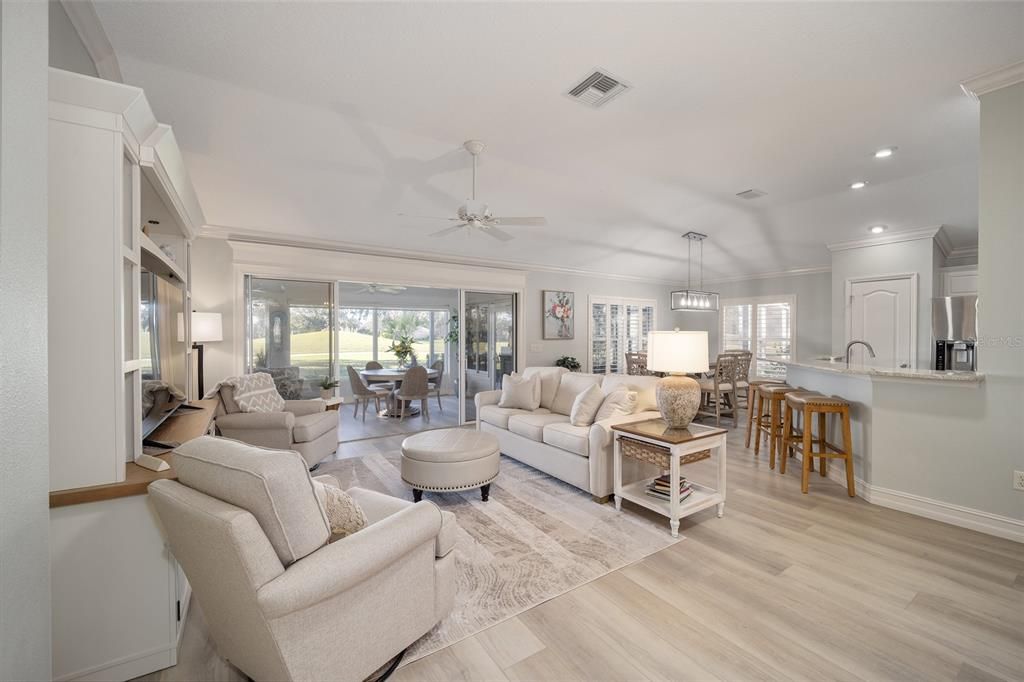 Standing in the entry to the primary suite looking toward the living room, kitchen, lanai and eating area