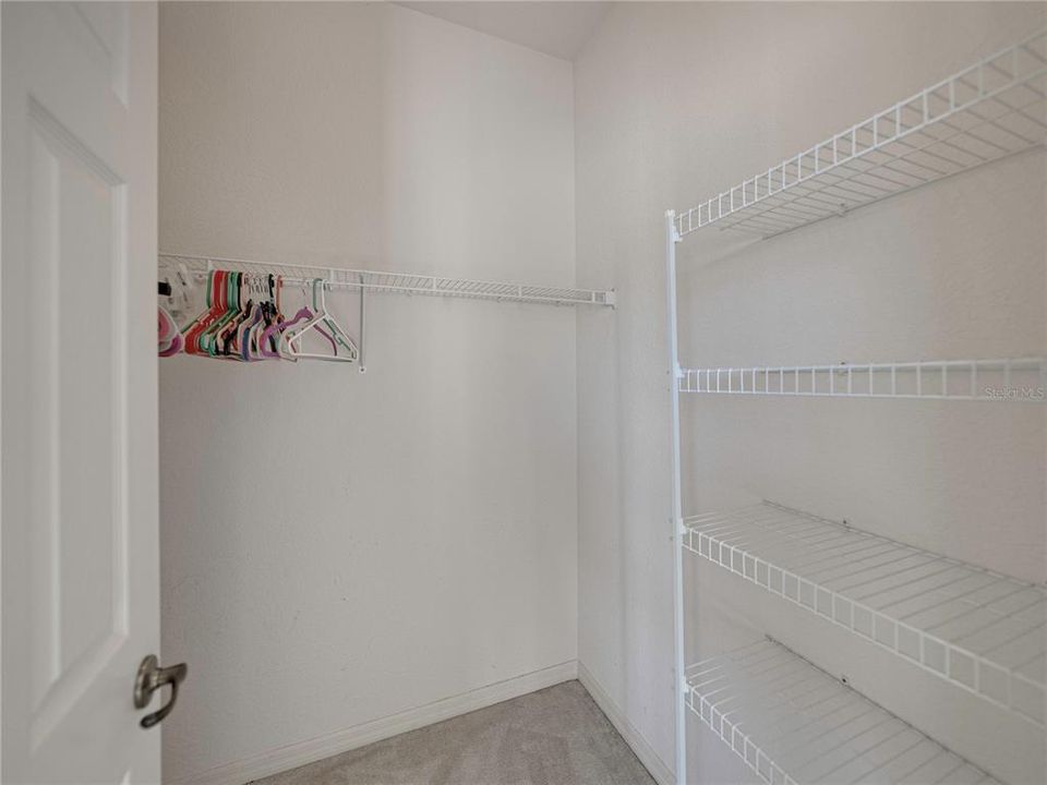 Walk in closet from primary bedroom