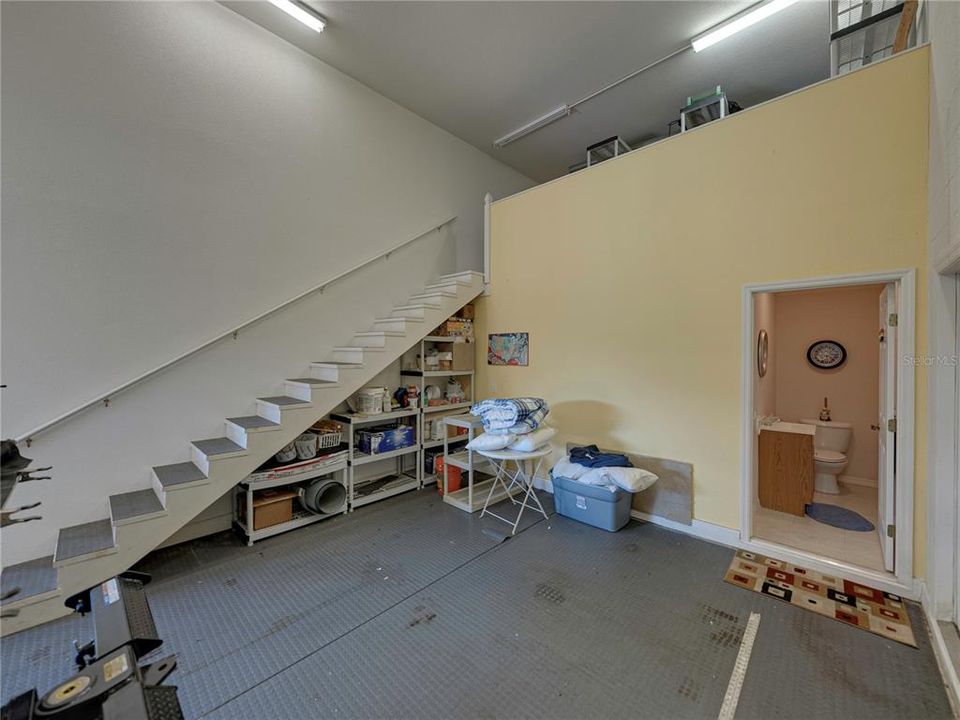 Stairs with handrail on one side for upstairs storage