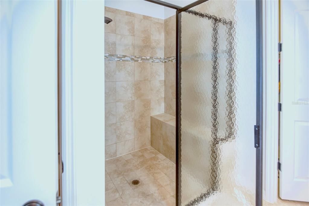 Even the shower tile is upgraded with a glass and marble listello inset