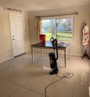 Standing at the other end of the room from the kitchen side looking to what is being used as the dining area.