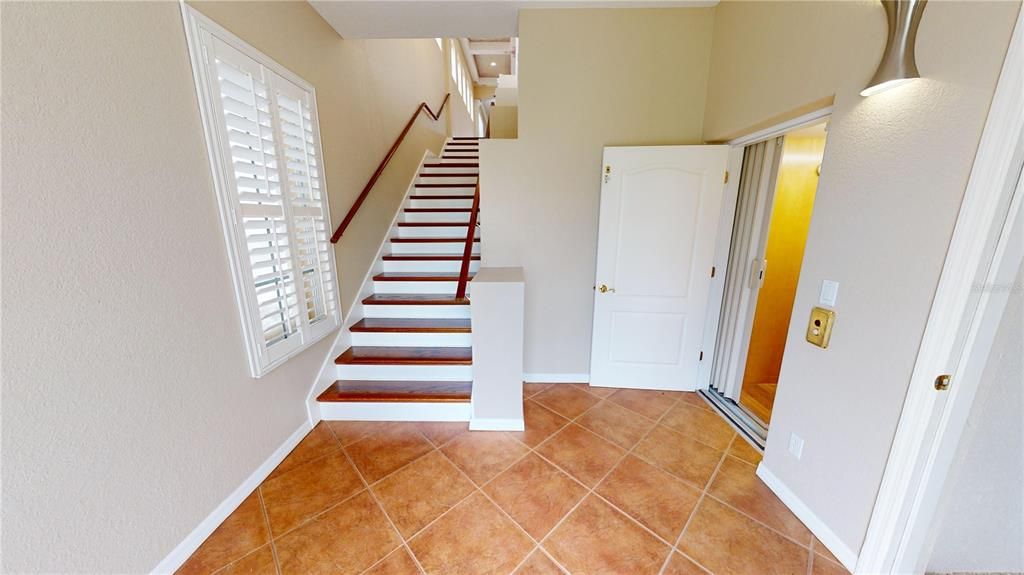 First floor foyer - Stairwell & elevator to living floor