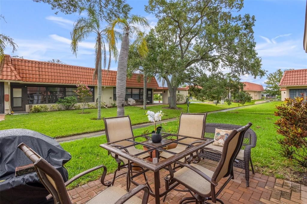 Backyard patio featuring freshly cut grass. Lawn maintenance is included in the monthly fees. The condo fees also include internet and cable services, pool maintenance, water, sewer, trash removal, exterior pest control and flood insurance.