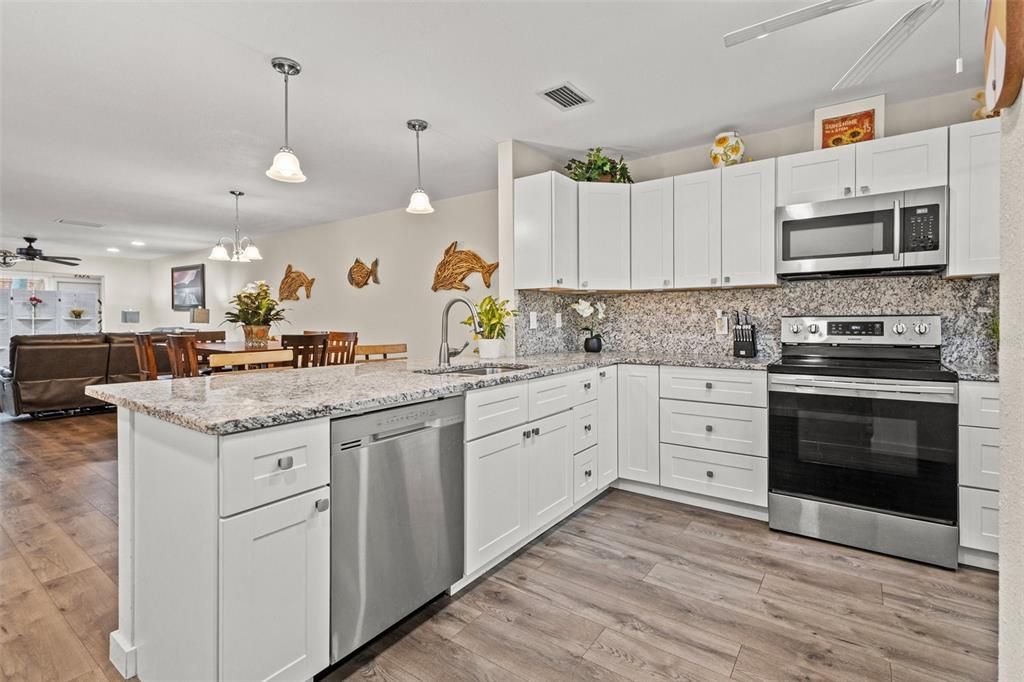 The kitchen features granite countertops, matching high-end stainless steel appliances and plenty of cabinet space.