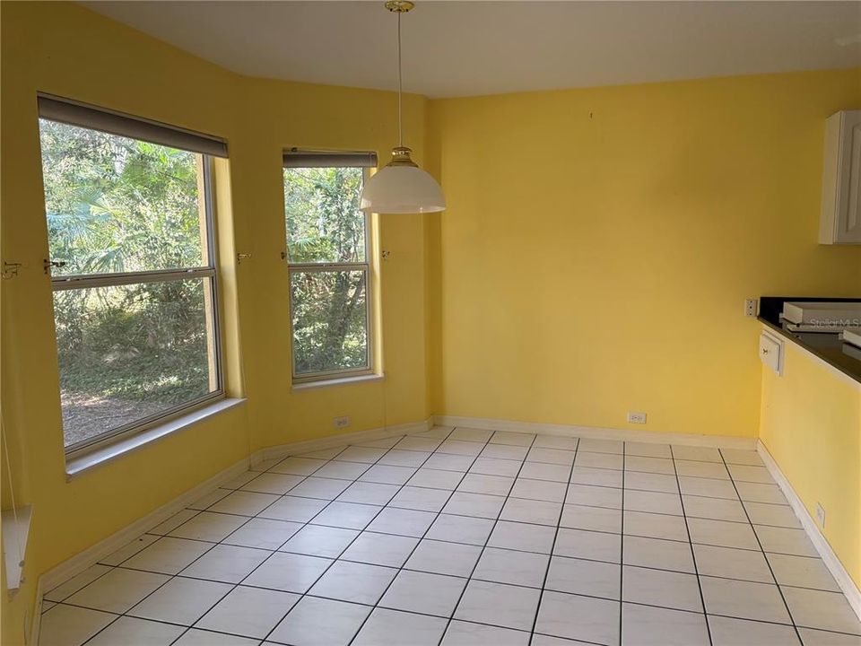 Eating area in kitchen overlooks yard