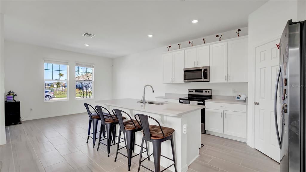 Kitchen showing great room as well