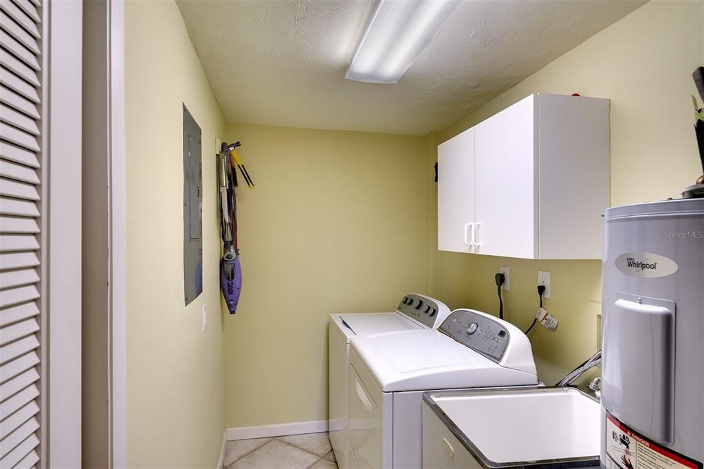 Large laundry room with lots of storage soace.