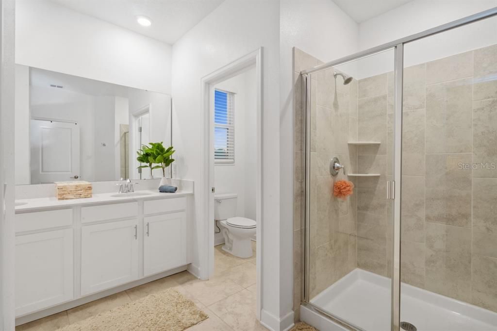 Spa inspired owner bath with his and her sinks