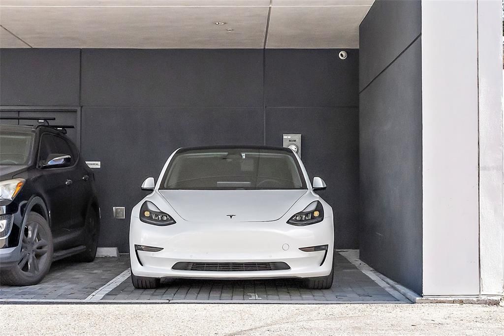 Corner Covered parking space with an electric vehicle charger metered directly into the unit - only unit in the building to offer both amenities