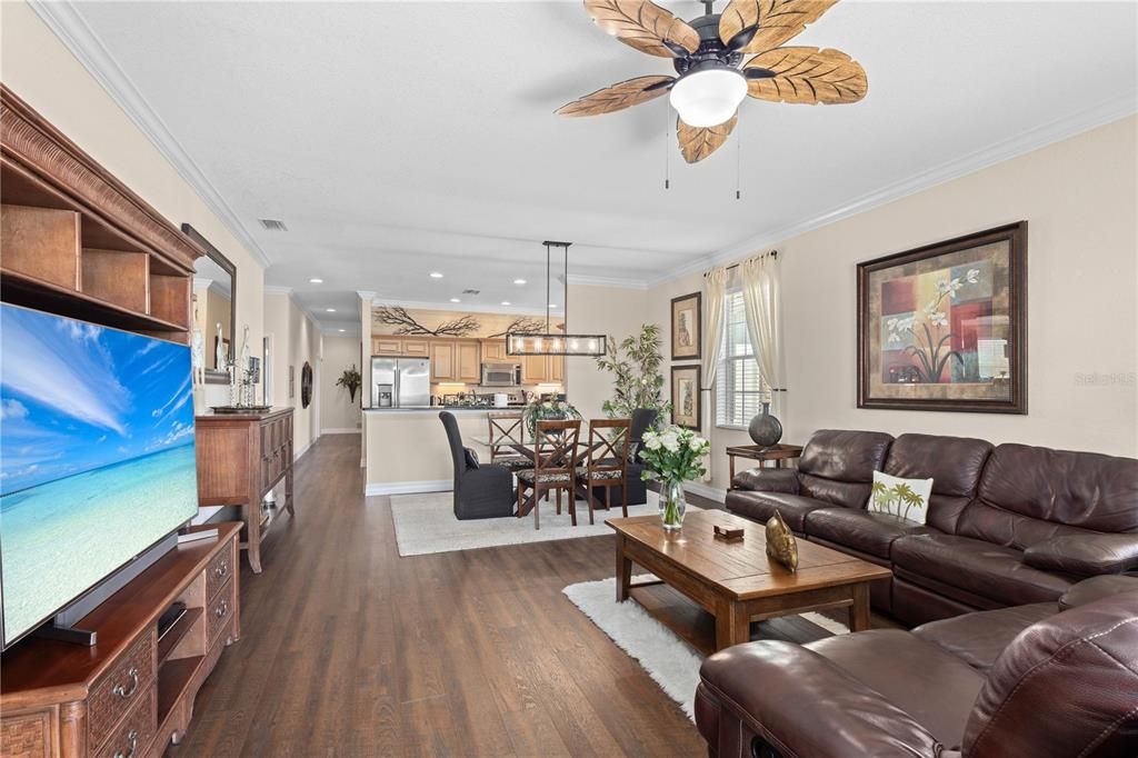 Comfortable Living Room with new flooring and crown molding.