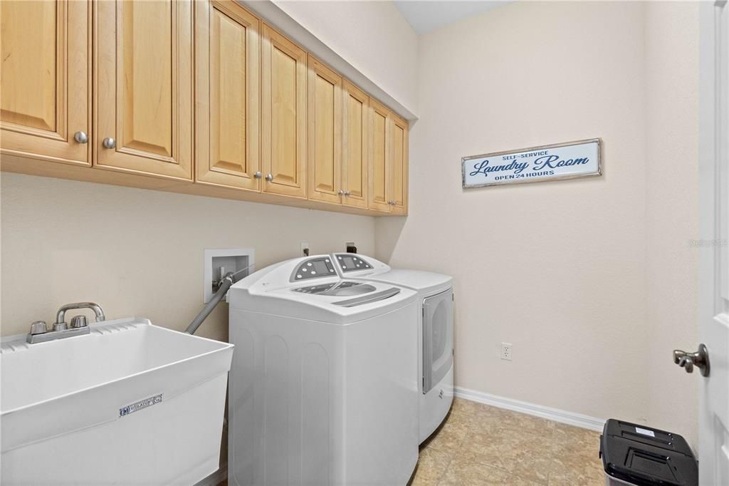 Laundry Room with cabinets, laundry tub, washer and dryer.