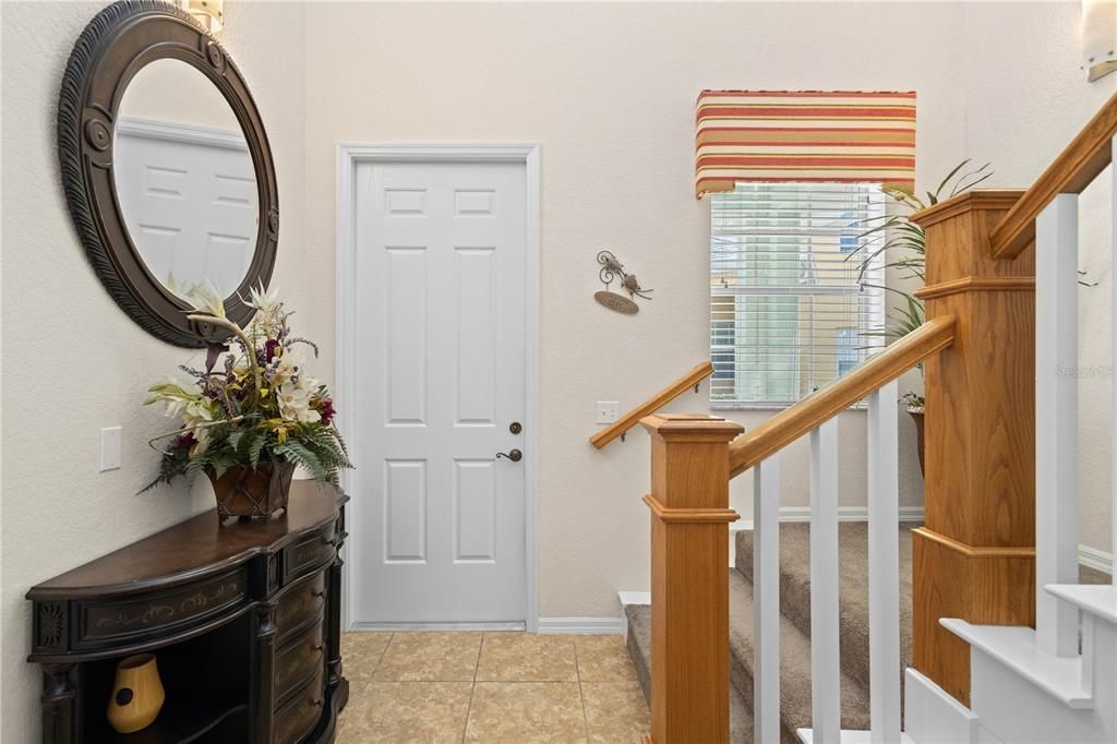 Foyer with access to the 2 car garage, storage area, spiral staircase and elevator.