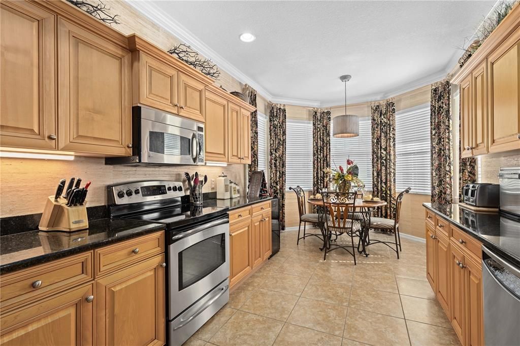 Beautiful Kitchen with plentiful cabinet and counter space and eat-in area.