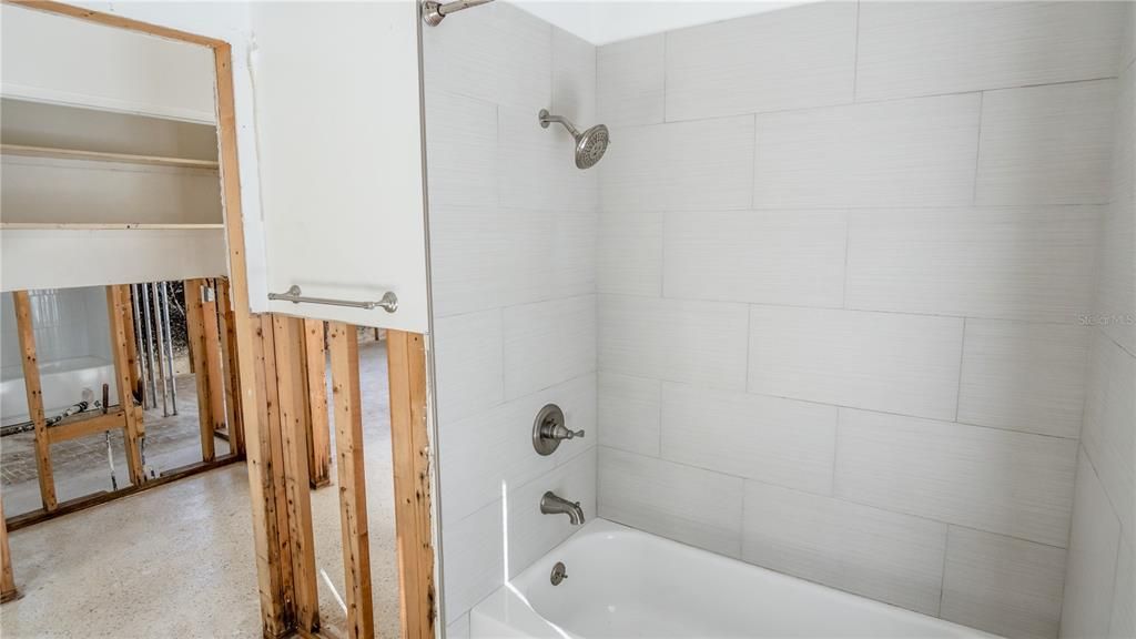 Hall Bathroom w/ Door Leading Out To Pool