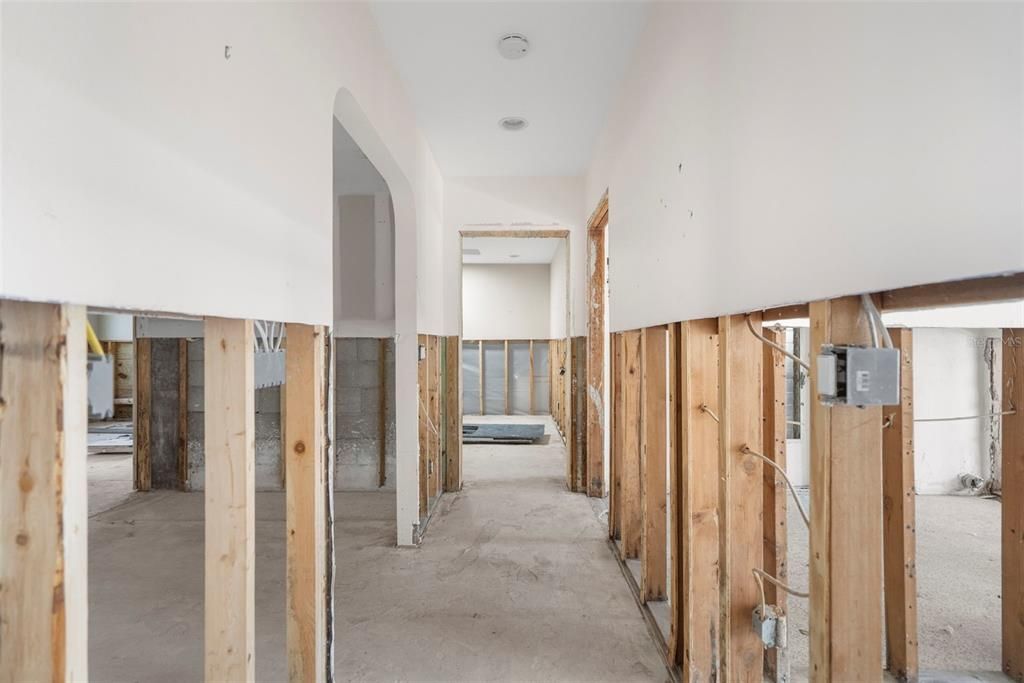 Hallway from main living. Laundry room to right. Kitchen to Left.Straight ahead is bonus room.