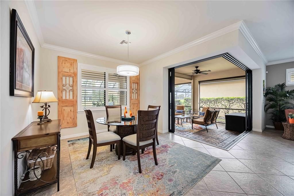 Dining area open to lanai for alfresco dining.