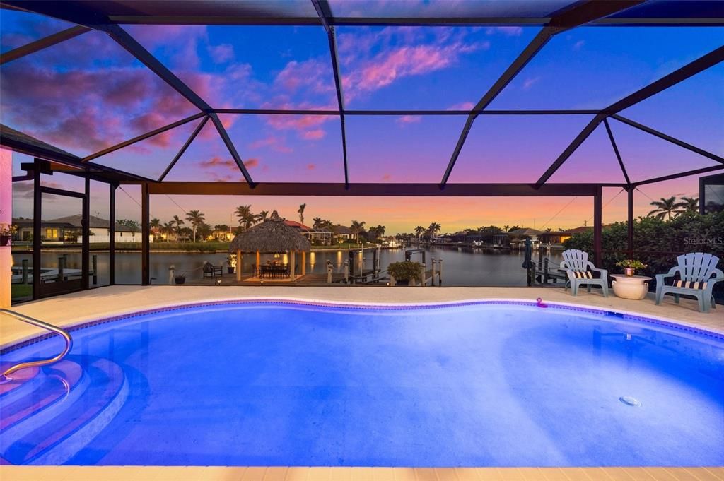 Evening View from the pool through the picture window screen to the water