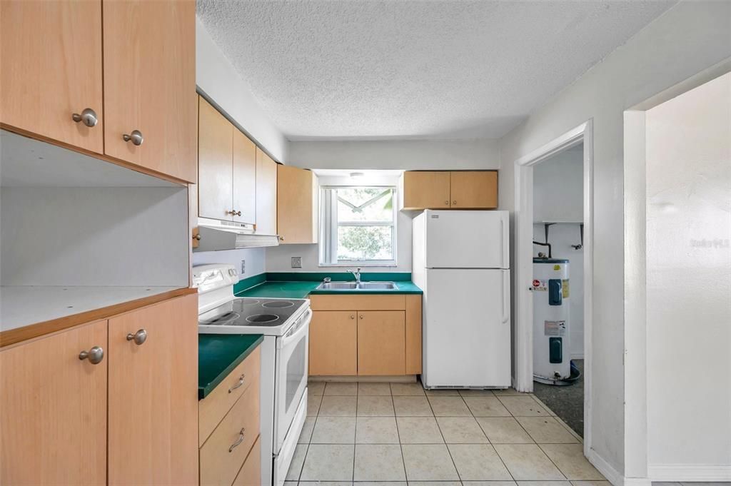 The window in the kitchen allows you to look over the fenced in backyard.