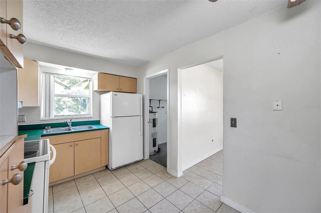 The utility room is off of the kitchen.