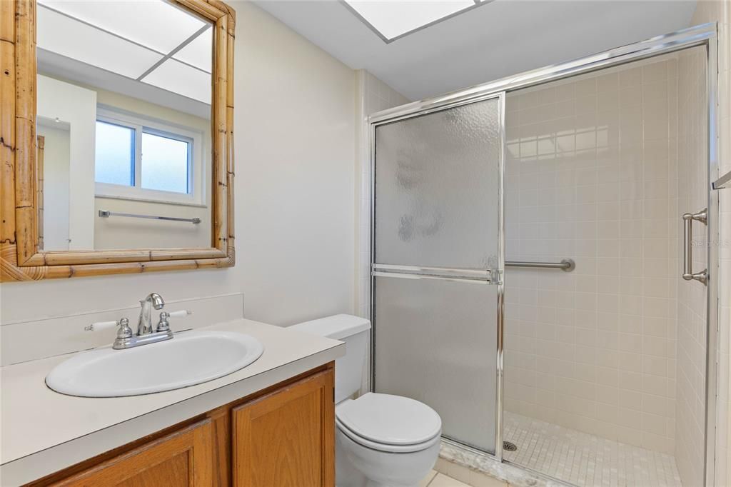 primary bathroom with glass-enclosed shower