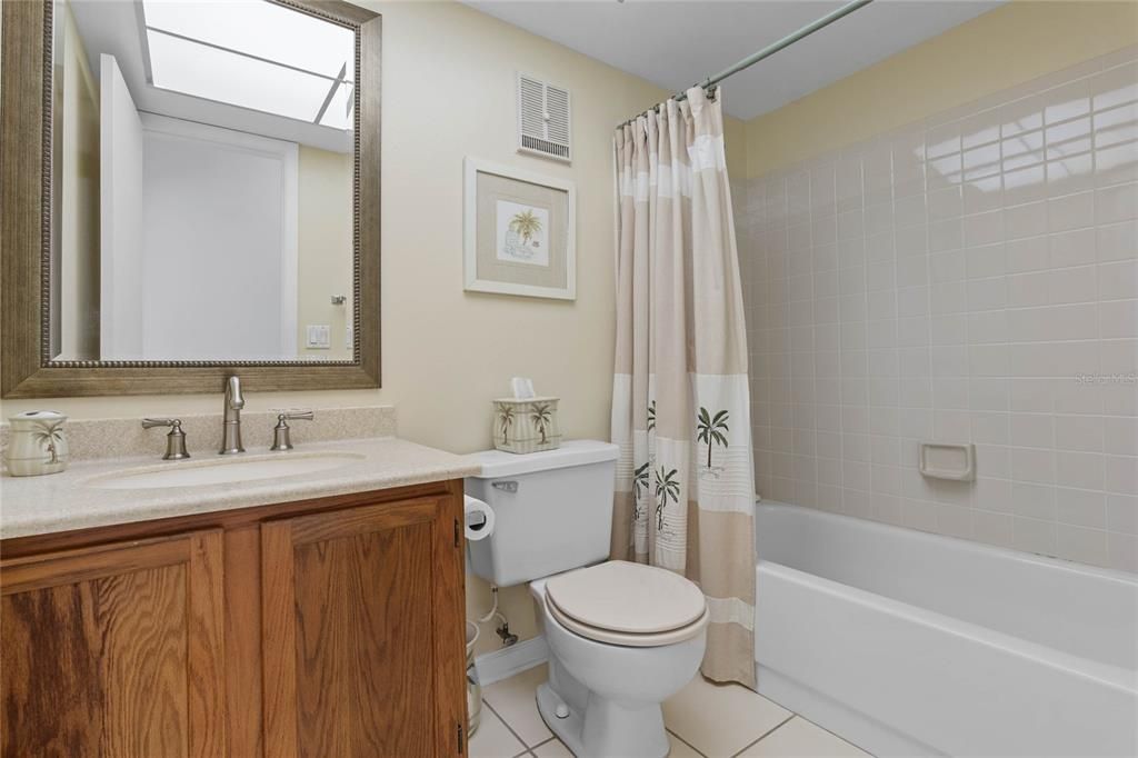 second bathroom with combination of tub and shower