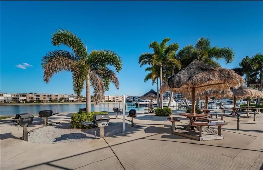 The Sun Island community boasts an array of amenities, including a charming barbecue area perfect for gatherings and relaxation while enjoying the water views.